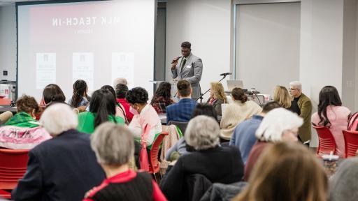 Karl Constant leads a prayer at North Central College's annual MLK Day.